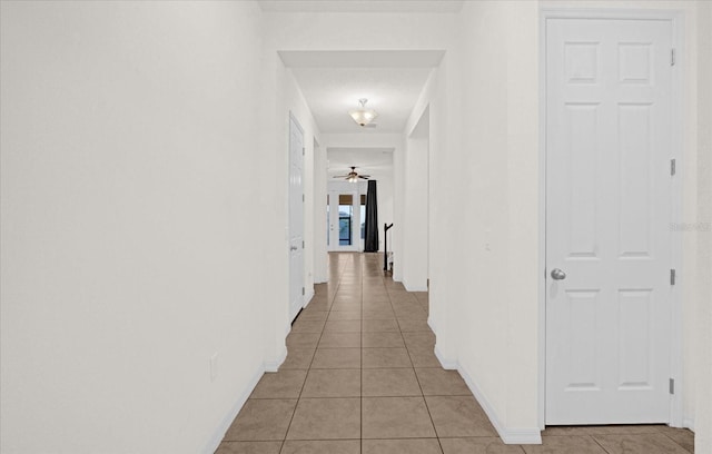 hall featuring light tile patterned flooring