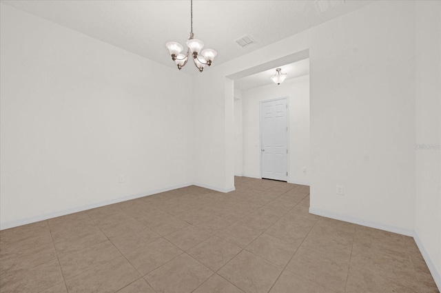 empty room featuring a chandelier