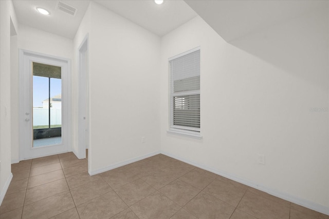 empty room with light tile patterned floors