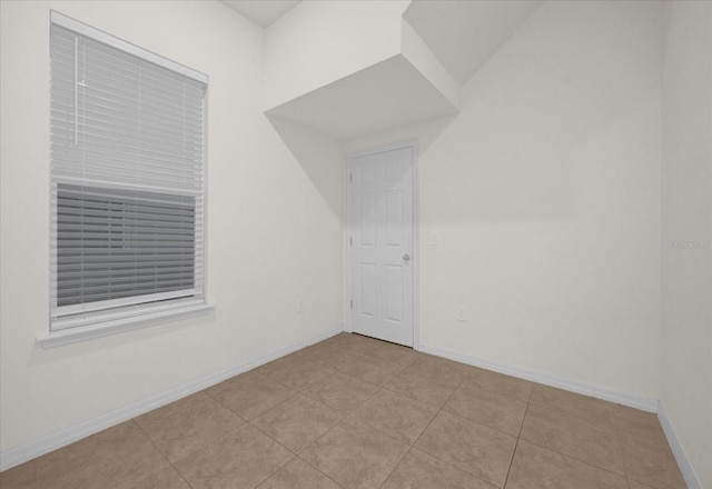 bonus room with light tile patterned flooring