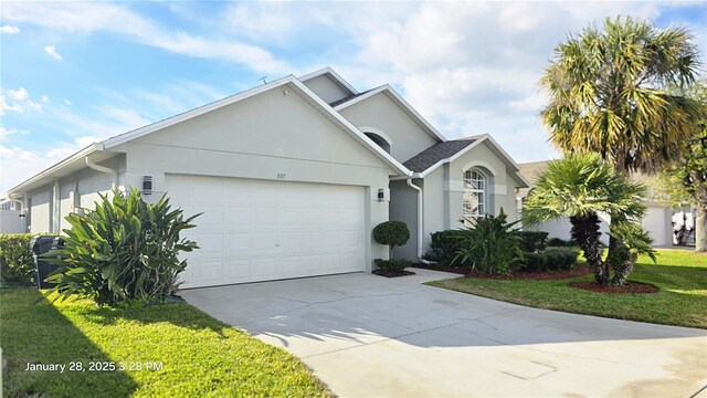 view of front of property with a garage and a front lawn