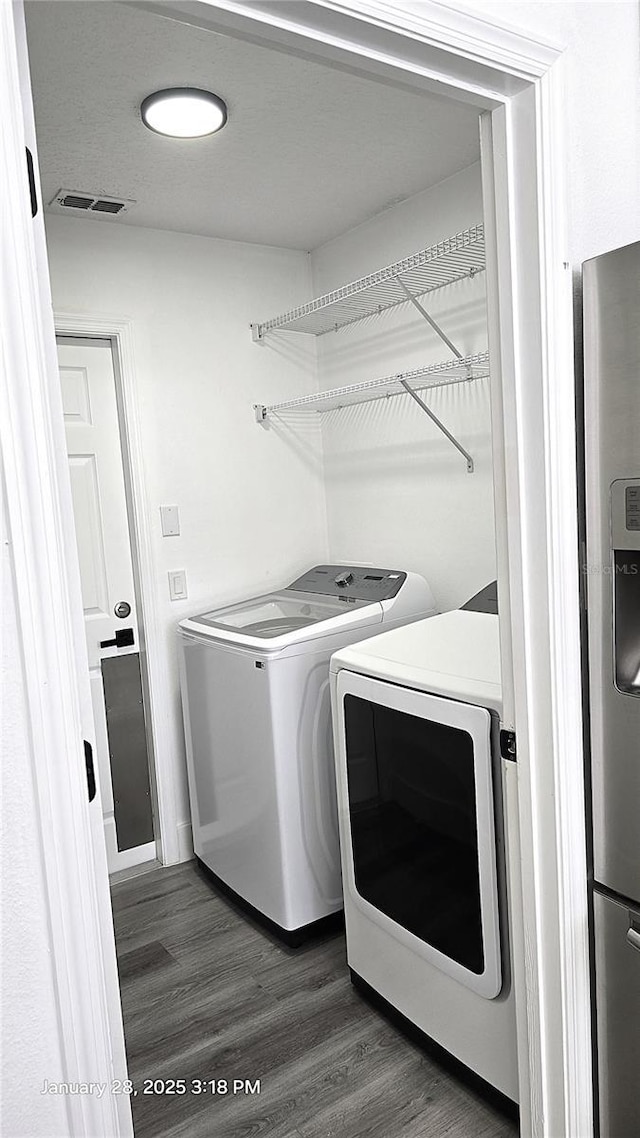 laundry area featuring dark hardwood / wood-style flooring and independent washer and dryer