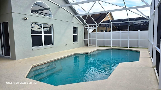 view of swimming pool featuring a patio and a lanai