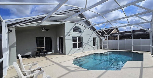 view of pool with ceiling fan, a lanai, and a patio area