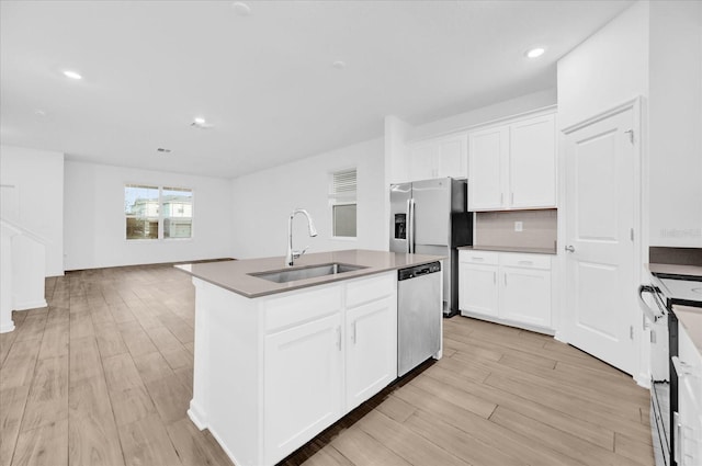 kitchen featuring white cabinetry, sink, an island with sink, and appliances with stainless steel finishes