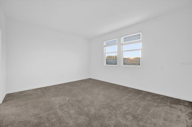 empty room featuring dark carpet