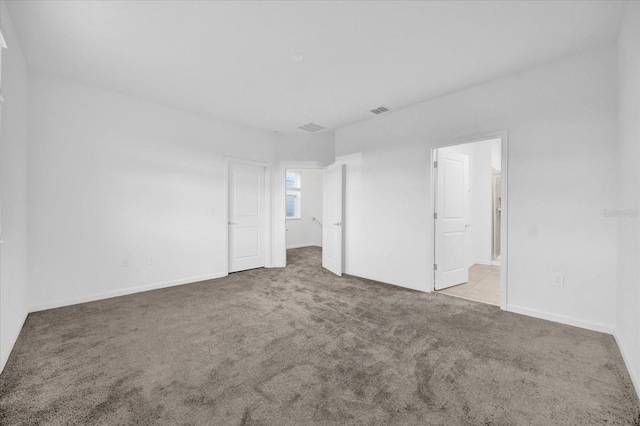 empty room featuring light colored carpet