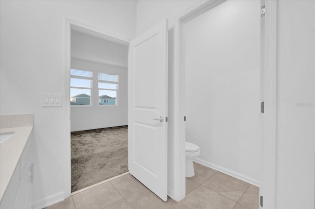 bathroom featuring vanity, tile patterned floors, and toilet