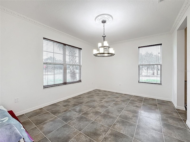 unfurnished dining area with a notable chandelier, crown molding, dark tile patterned flooring, and a textured ceiling