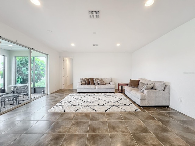 unfurnished living room with dark tile patterned flooring