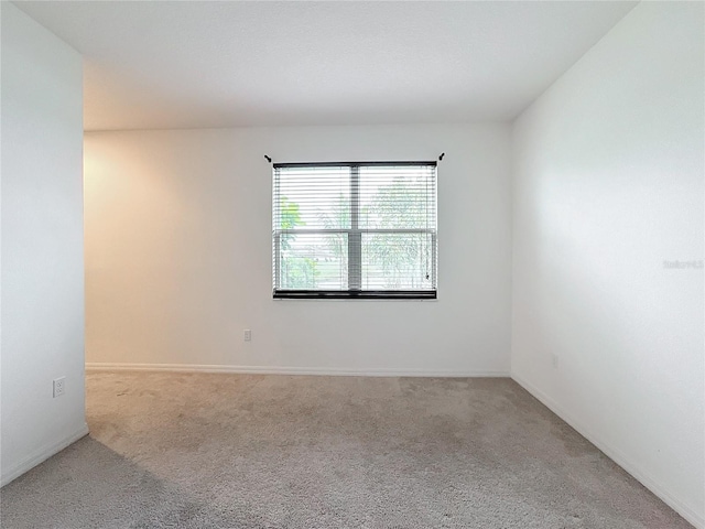 unfurnished room with light colored carpet