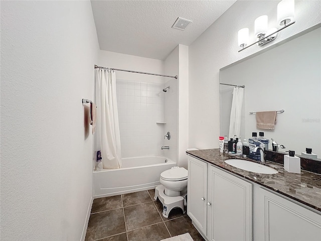 full bathroom with tile patterned flooring, vanity, shower / tub combo, toilet, and a textured ceiling