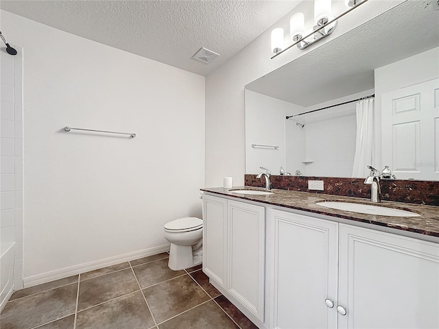 full bathroom featuring tile patterned flooring, vanity, shower / tub combo, toilet, and a textured ceiling