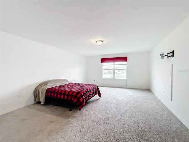 bedroom featuring a textured ceiling and carpet flooring