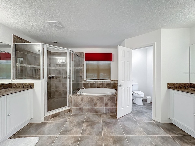 full bathroom with shower with separate bathtub, vanity, a textured ceiling, and toilet