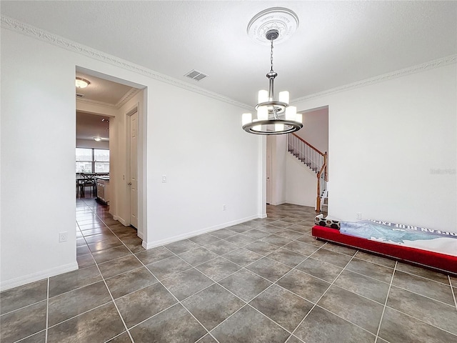 tiled spare room with crown molding and an inviting chandelier