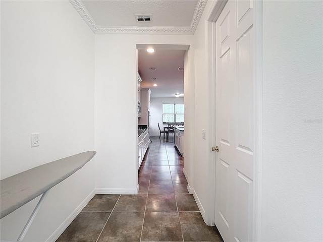 hall with dark tile patterned flooring