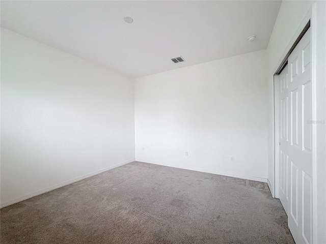 unfurnished bedroom featuring carpet flooring and a closet