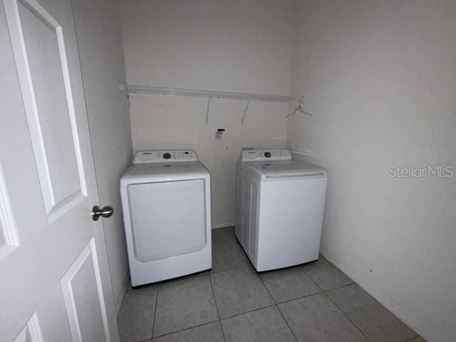 laundry room with light tile patterned floors and independent washer and dryer