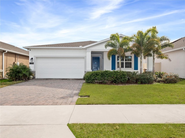 single story home featuring a garage and a front yard