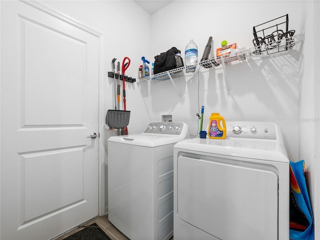 clothes washing area featuring independent washer and dryer and tile patterned floors