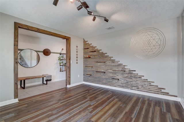 interior space featuring hardwood / wood-style floors and a textured ceiling