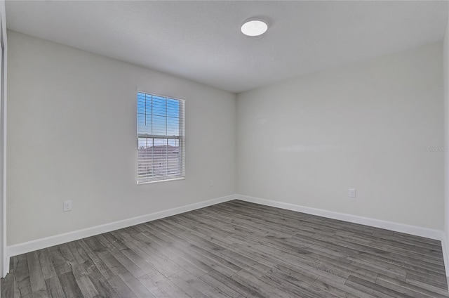 spare room with hardwood / wood-style floors