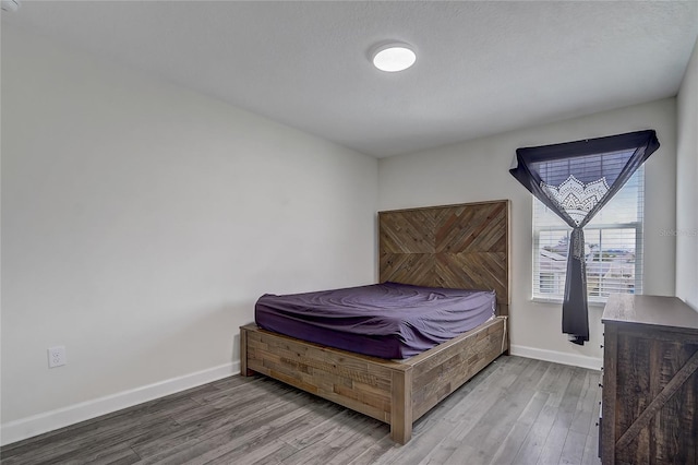 bedroom with hardwood / wood-style flooring