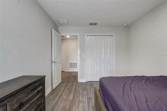 bedroom with a closet and light hardwood / wood-style flooring