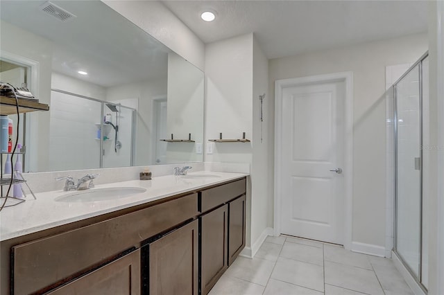 bathroom featuring vanity, tile patterned floors, and walk in shower