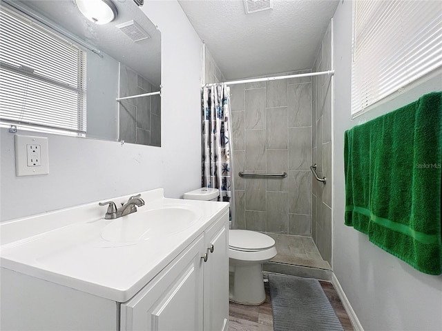 bathroom featuring toilet, a shower with curtain, a textured ceiling, vanity, and hardwood / wood-style flooring