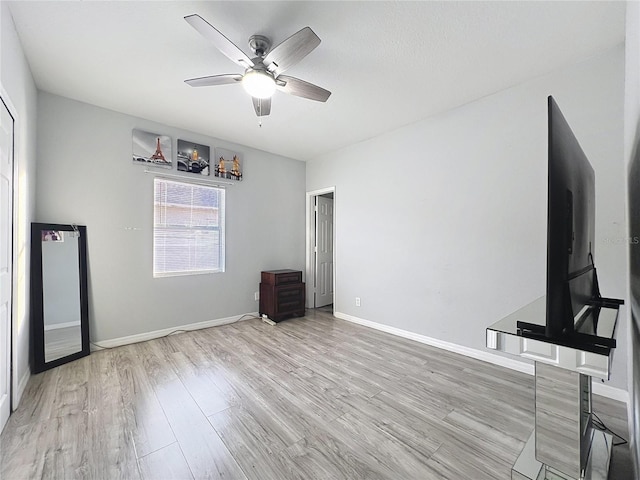 unfurnished living room with ceiling fan and light wood-type flooring