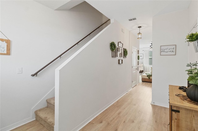 stairs featuring wood-type flooring