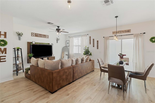 living room featuring ceiling fan and light hardwood / wood-style flooring