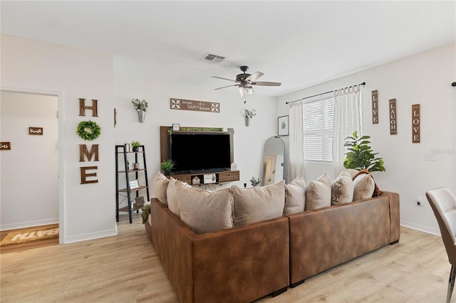 living room with ceiling fan and light wood-type flooring