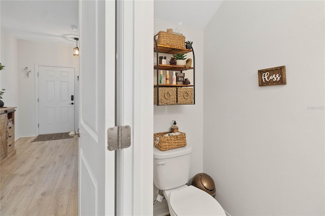 bathroom featuring wood-type flooring and toilet