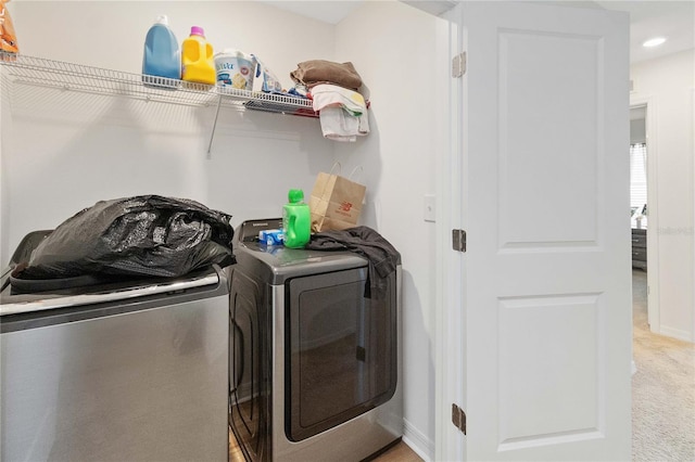 washroom with light colored carpet and washer and clothes dryer