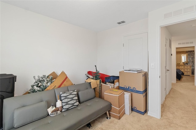 living area featuring light carpet