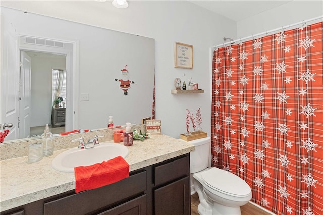 bathroom with vanity, toilet, and a shower with shower curtain