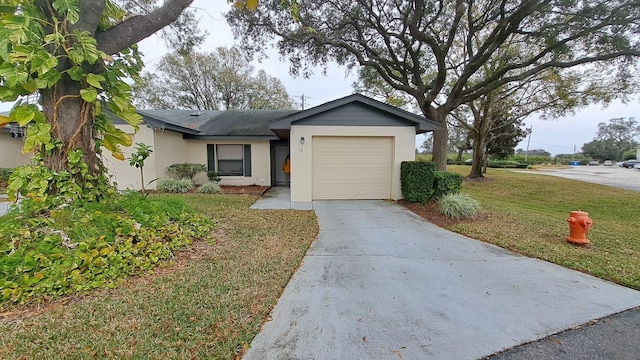 ranch-style home featuring a garage and a front yard