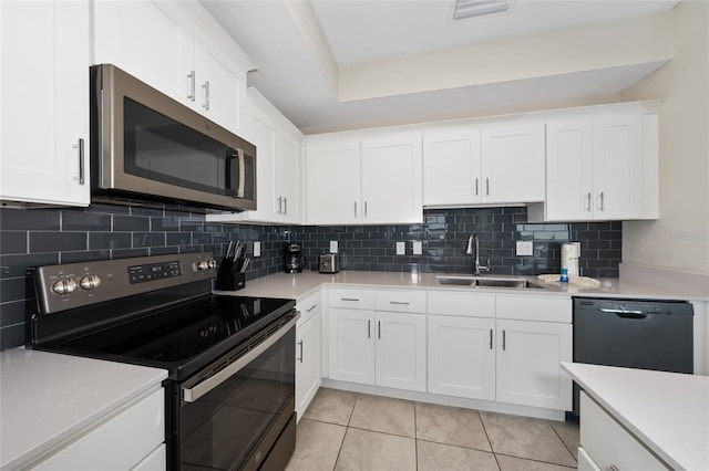 kitchen with white cabinetry, sink, and black appliances