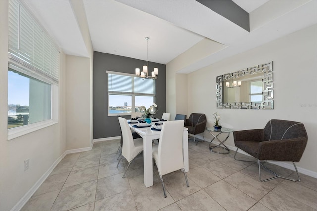 dining space featuring light tile patterned floors and a chandelier