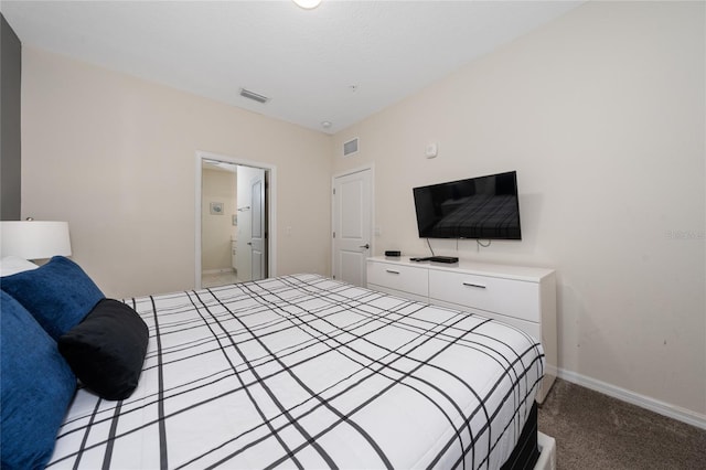 carpeted bedroom with ensuite bath