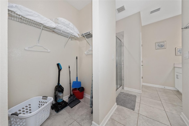 bathroom with tile patterned flooring, vanity, and a shower with shower door