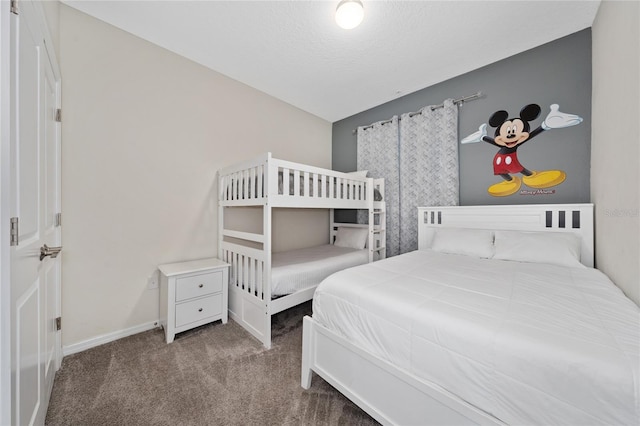 bedroom featuring carpet floors and a textured ceiling