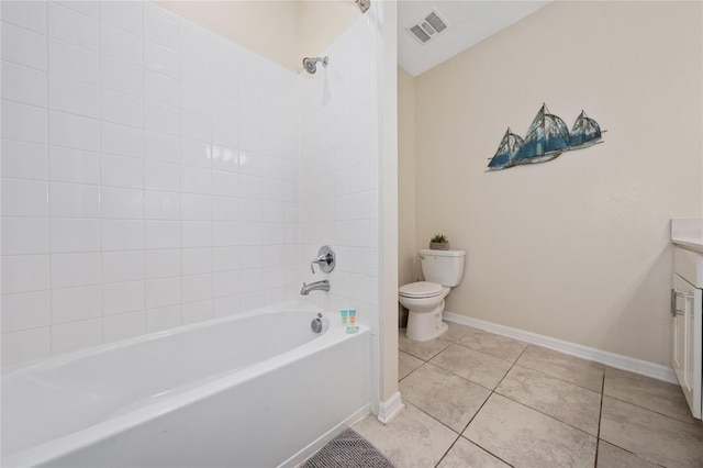 full bathroom with tile patterned flooring, tiled shower / bath, vanity, and toilet