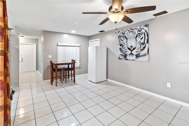 interior space with ceiling fan and light tile patterned floors