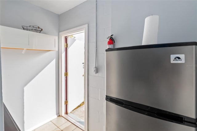 entryway with light tile patterned flooring