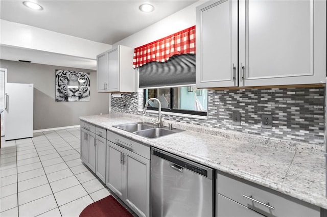 kitchen featuring gray cabinets, dishwasher, sink, decorative backsplash, and white fridge