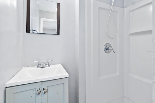 bathroom with a shower and vanity